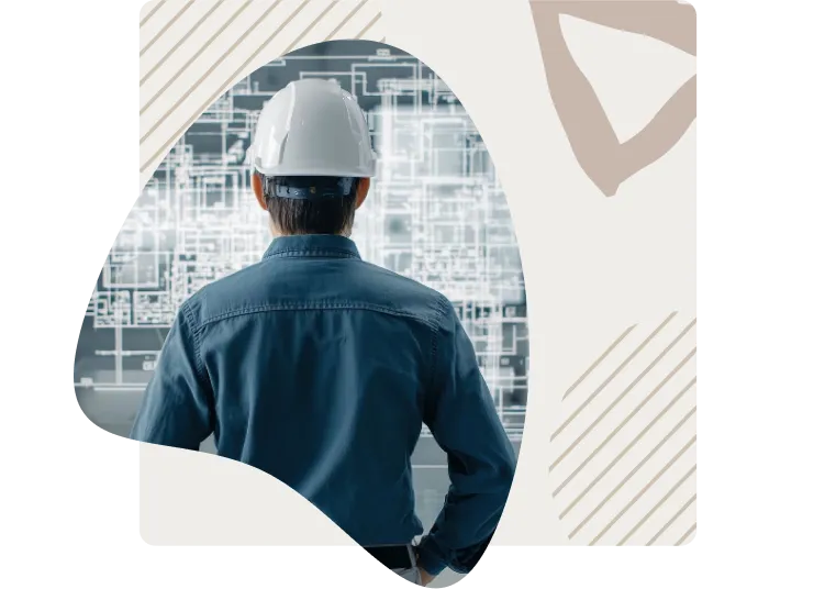 Ingegnere di Astra Engineering al lavoro con disegni tecnici